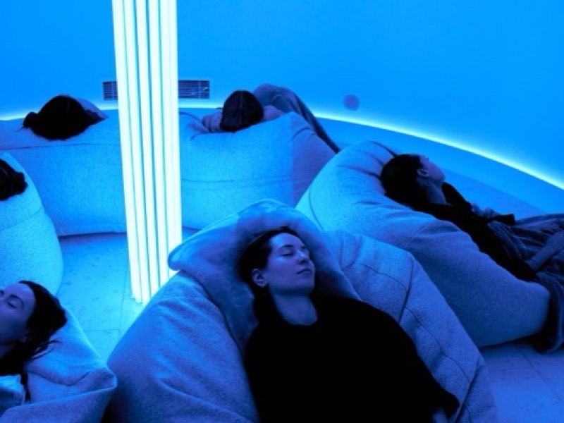 Guests lying still under blue light in the EQ dome